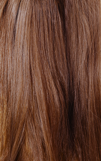 Brown uncombed long hair forming the background.