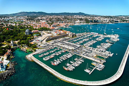 Cascais coastal resort town in Lisbon at sunny summer day, drone point of view. Turquoise waters of the Atlantic Ocean, rocky coastline, marina with sailing boats. Travel, tourism concept. Portugal