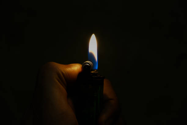 istock The flame of a lighter in the darkness. 1580952236