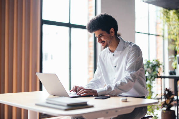 Free Stock Photo of Young Adult Man In White Shirt Smiling and Using a ...