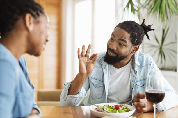 Happy black couple having a meal together at home
