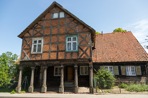 Zulawki, Zulawy, Poland - 15 June 2019: Traditional buildings of peasant architecture in Zulawy Wislane. Spring season. Sunny day.