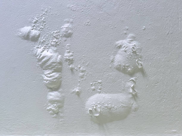 Swollen bubbles of paint on the ceiling.  Poor repair, problems from high humidity, peeling and peeling paint