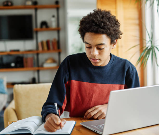 istock education laptop student computer teenager studying boy learning homework study young school teenage black technology happy internet sitting college online man notebook using 1581047738
