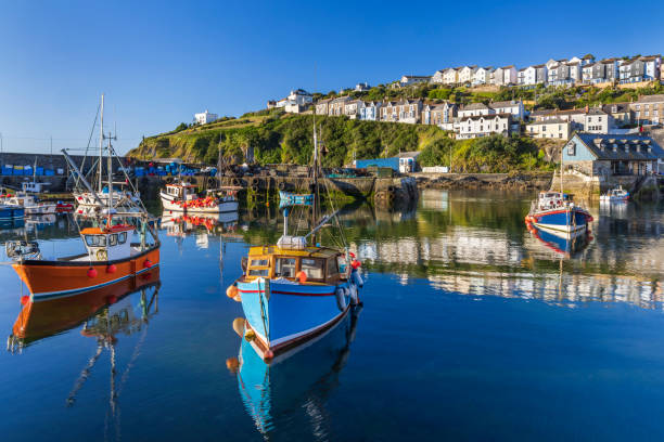 Waterfront view of Mevagissey in Cornwall The tranquil beauty of Mevagissey Harbour, with its Cornish charm and bustling fish market. cornwall england stock pictures, royalty-free photos & images