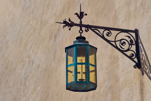 Vintage forged street lamp on wall