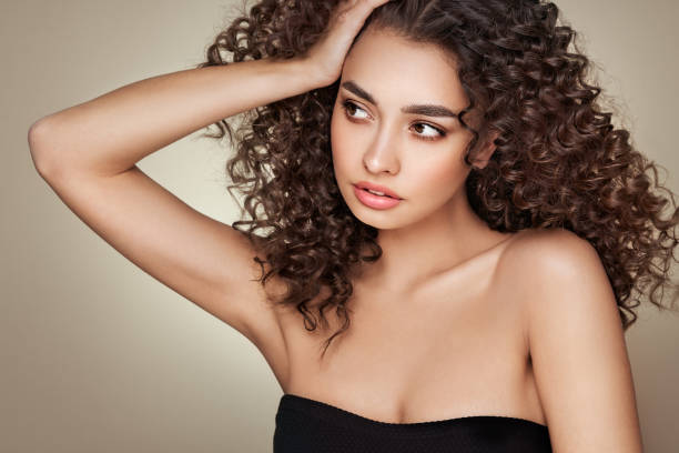 istock Beautiful smiling woman with afro curls 1581058997