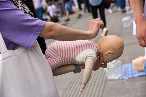 Demonstration of first aid for choking infant.