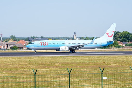 Brussels, Belgium - July,07,2023: TUI  airline fleet airbus A320 landing at Brussels Zaventum  airport.