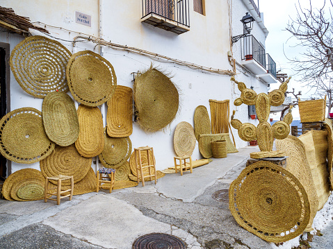 Pampaneira, Spain - February 24, 2023: wicker basket wall in the streets in Pampaneira village, Andalusia, Spain