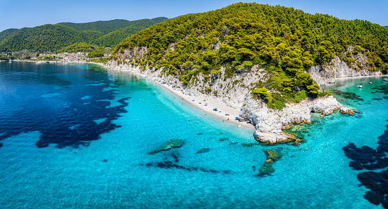 The beautiful coast of Skopelos island at Hovolo beach, Sporades, Greece, with turquoise sea and lush pine tree forest