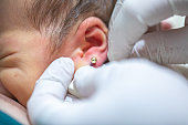 Piercing a newborn's ear to put an earring