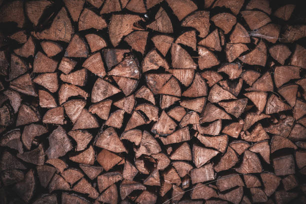 Grainau, Bavaria, German - March 4, 2023: Logs of wood, cut, split, and stacked together.