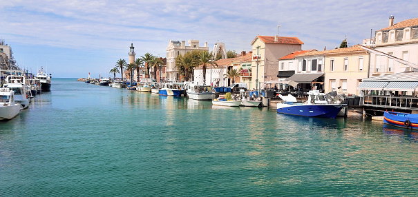 The Grau du Roi canal, with many boats moored along the quays. Small French seaside resort, in the Gard.