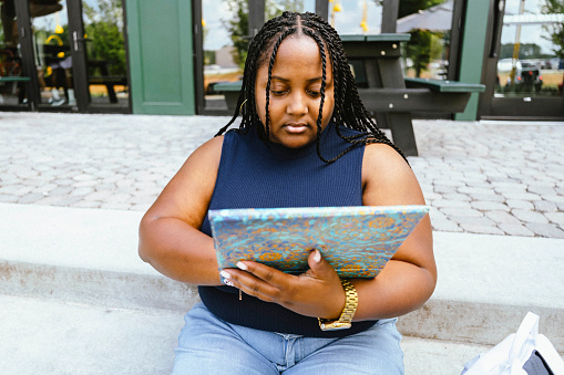 African American young woman looking at tablet
