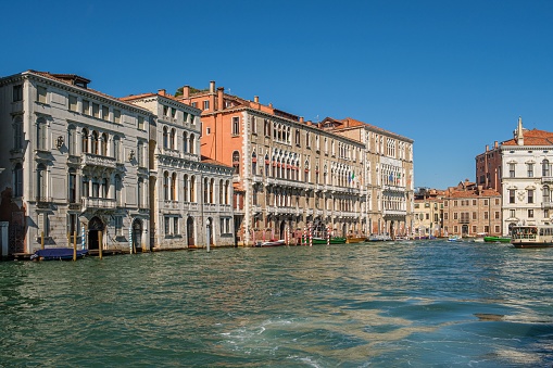 Venice, Italy – September 19, 2022: A scenic river with a historic backdrop of centuries-old buildings on either side, providing a picturesque view