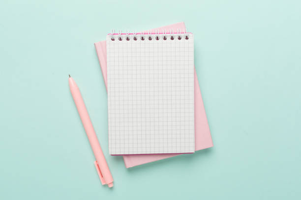 istock Notebooks with pen on color background, top view 1581302557