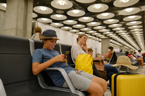 istock Mother and children waiting for flight 1581303074