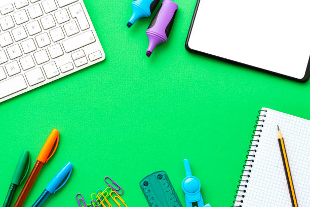 istock Green workstation with computer keyboard, Digital tablet and office supplies. Copy space 1581309486