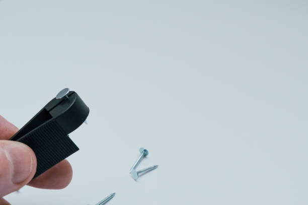 istock Practical solutions; holding nail with clothespin in order to avoid injury. DIY, home repair and fix. 1581311702