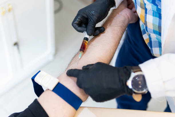 istock Nurse drawing blood from patient 1581342052