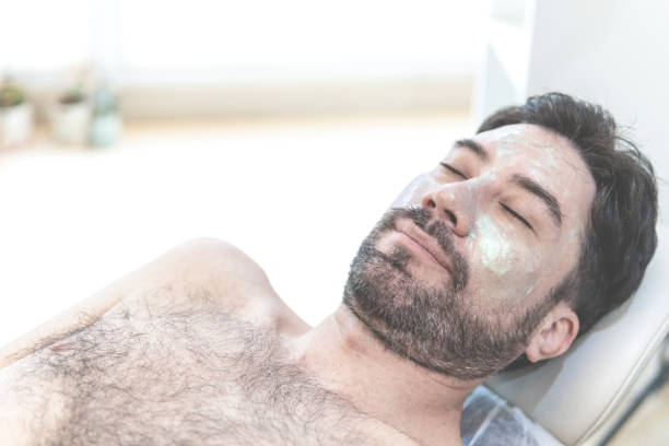 istock Latino man getting cosmetic treatment on his face 1581346966