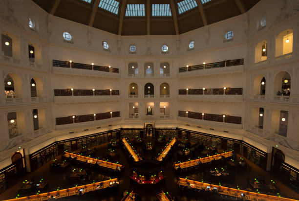Pictured here in June 2017 is the interior dome and La Trobe reading room of the State Library of Victoria, Melbourne's most famous library and the oldest in Australia.  Featuring a radial design and green lampshades, the reading room is a comfortable spot to study.  It is one of many reading rooms in the library, which spans an entire city block and holds a collection of over two million books.