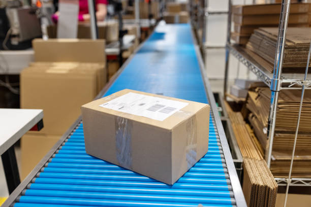 istock Package on a conveyor belt in the warehouse 1581412597