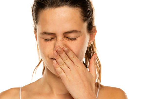 istock A young woman has itching in the nose on white background 1581430997