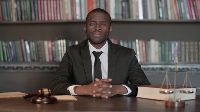 African Male Lawyer with Finger on Lips to Keep the Secret