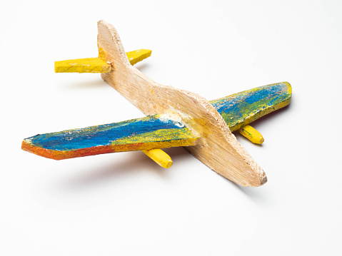 Wooden aeroplane craft on a white isolated background