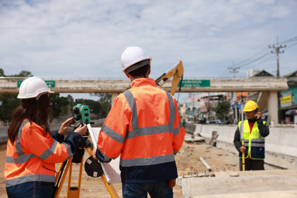 Construction engineer talking to architect at industrial construction site in road construction site