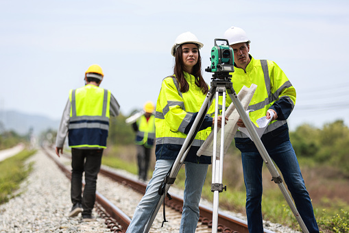 Civil engineers teamwork at road construction sites to supervise new road construction throughout the railway