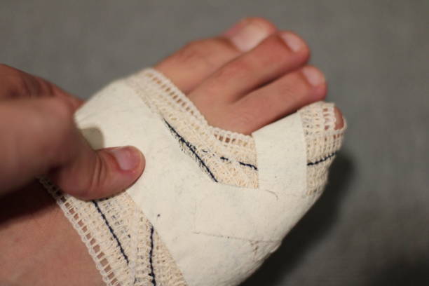 istock Person Fixing Bandage on his Foot 1581531593