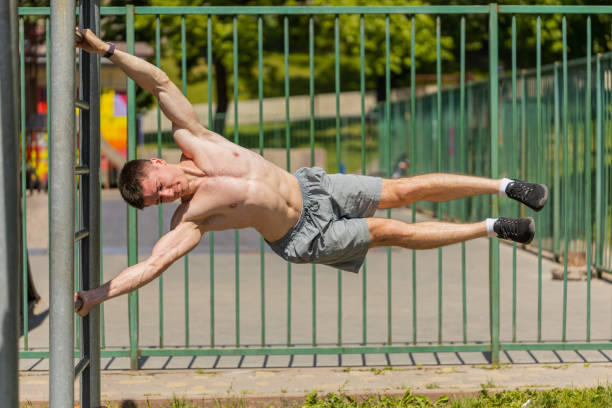 istock Athletic caucasian topless muscular man doing human flag exercise, strength gymnastics elements 1581532674
