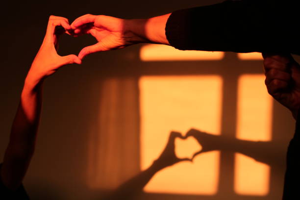 istock Mother and Son Making Heart Symbol 1581536948