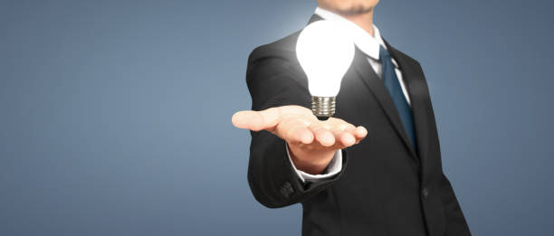 istock Humans hold light bulbs in hand innovative technology 1581561574