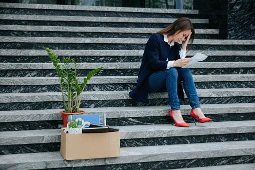 Challenging Joblessness Upset Woman Contemplating on Staircase. The Sad Reality of Joblessness A Troubled Female Worker