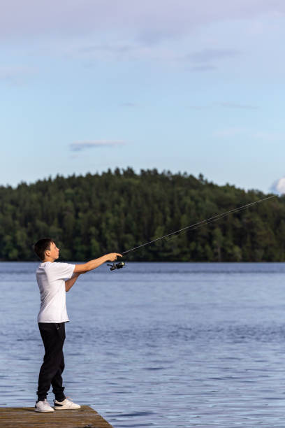 pesca adolescenziale , svezia - sweden fishing child little boys foto e immagini stock