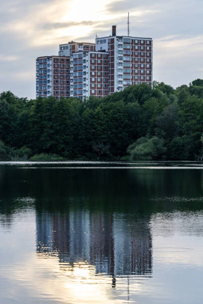 Stockholm, Sweden A residential tower in the Grondal district reflects in the Trekanten Lake.