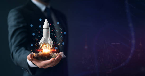 Startup, hand shows a rocket and icons stock photo