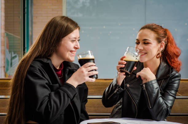 istock Two beautiful women having fun together in a bar 1581628077
