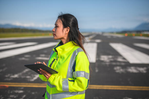 istock Asian Female Airfield Operations Officer Using A Digital Tablet 1581631393