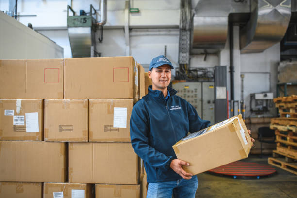 istock Asian Delivery Guy With Cardboard Package In Hands 1581633801