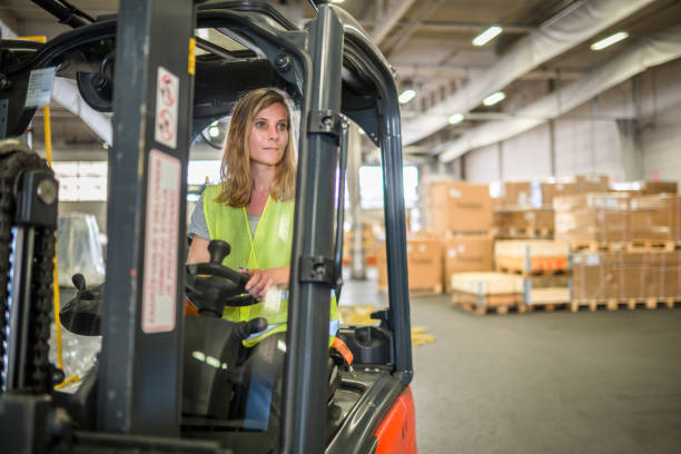 istock Caucasian Female Airport Warehouse Worker On A Forklift 1581633951