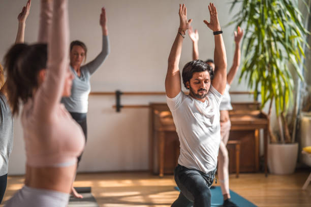 istock Multiracial Group of Yoga Practitioners Together in Studio 1581635139