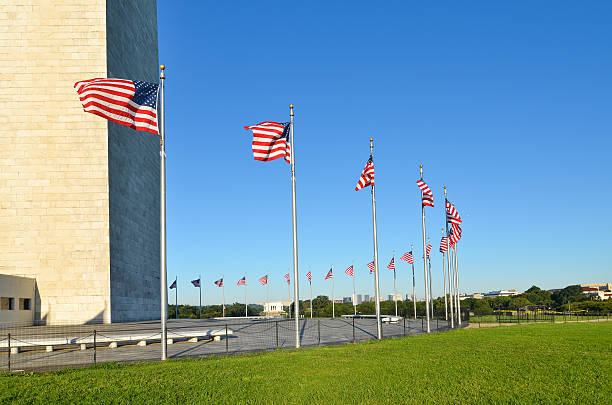 istock Washington Monument with waving United States flags 158165376