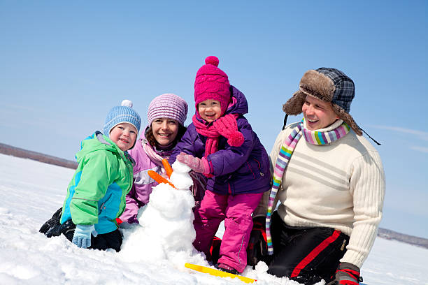 istock Happy family making snowman 158168332