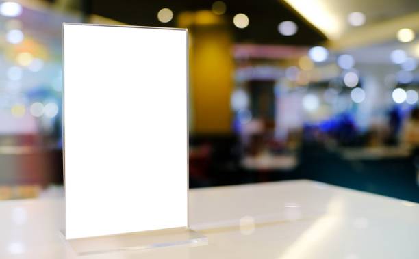 istock Mock up Menu frame standing on wood table in Bar restaurant cafe. space for text 1581723000
