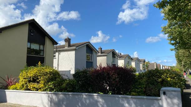 istock Blue sky, white clouds. Background.Beautiful nature in Ireland. Summer day . Identical private houses for a family. Acquisition of real estate. 1581754890